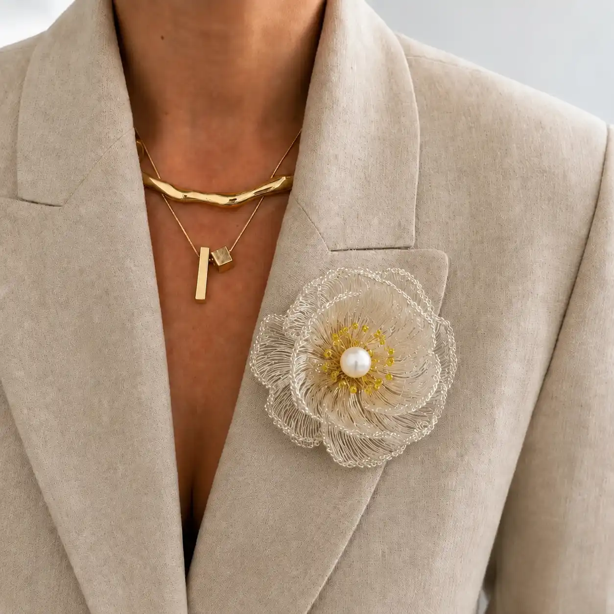 Model wearing an OREYNE handmade silver-wire brooch